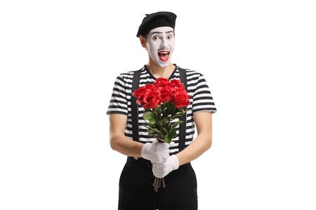 Excited pantomime man holding a bunch of red roses isolated on white backgroundの写真素材