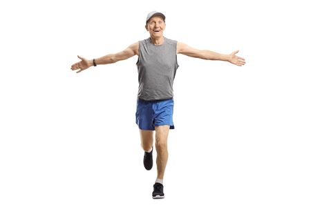 Full length portrait of an elderly man running and spreading arms isolated on whiteの写真素材