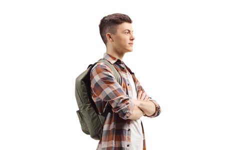 Young guy with a backpack standing with arms crossed isolated on whiteの写真素材
