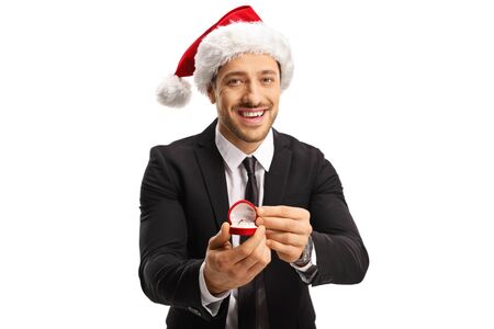 Young man proposing with a ring on Christmas isolated on white background