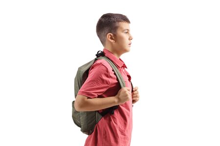 Schoolboy standing with a backpack isolated on whiteの写真素材