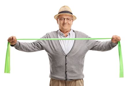 Elderly man exercising with a rubber band isolated on white backgroundの写真素材