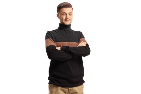 Young smiling guy wearing a turtleneck sweather posing with arms crossed isolated on white backgroundの写真素材