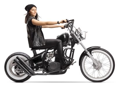Female biker on a custom black chopper isolated on whiteの写真素材