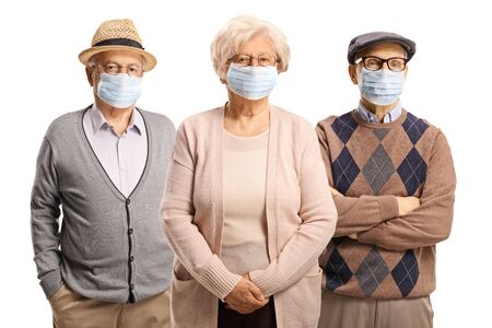 Senior people with anti-virus face masks isolated on white backgroundの写真素材