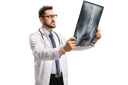 Young male doctor examining an x ray scan isolated on white background