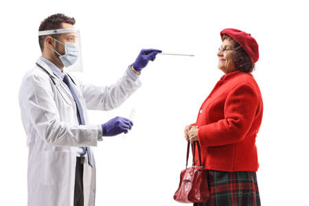 Male doctor with protective equipment taking a cotton swab test from an elderly woman isolated on...