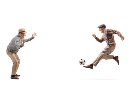Two grandfathers playing soccer isolated on white background