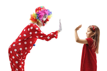 Clown making high-five gesture with a girl isolated on white backgroundの写真素材
