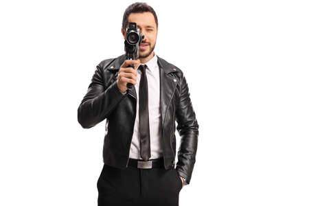Man in a leather jacker recording with a vintage camera recorder isolated on white background