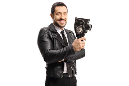 Man in a leather jacket recording holding a vintage 8 mm camera isolated on white background