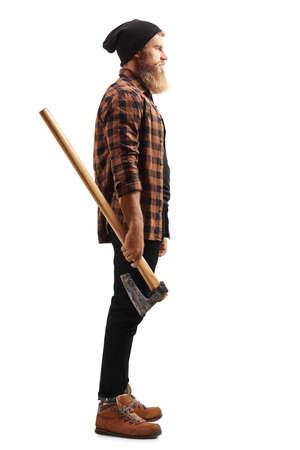 Full length profile shot of a serious bearded man holding a hatchet isolated on white backgroundの写真素材