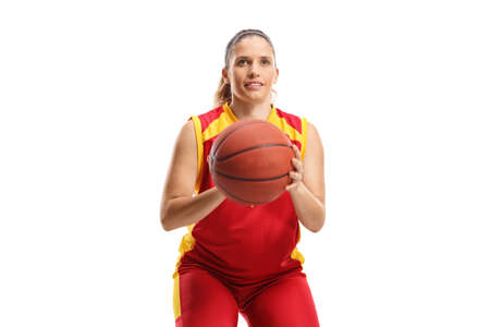 Female basketball player preparing to shoot a ball isolated on white backgroundの写真素材