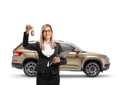 Businesswoman holding keys from a SUV isolated on white background