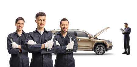 Team of auto mechanic workers with a SUV isolated on white background