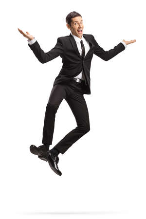 Excited young businessman in suit and tie jumping isolated on white backgroundの写真素材