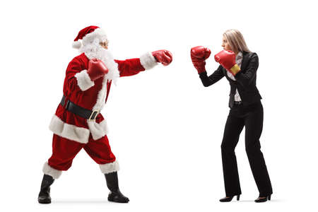 Full length profile shot of santa claus boxing with a businesswoman isolated on white backgroundの写真素材