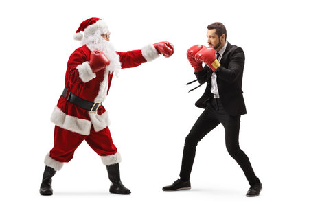 Full length profile shot of a businessman and santa claus training box isolated on white backgroundの写真素材
