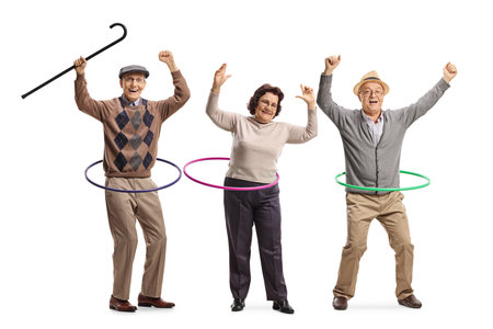 Happy elderly people spinning hula hoops isolated on white backgroundの写真素材