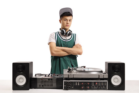 Young male dj with vinyl turntable posing with crossed arms isolated on white backgroundの写真素材