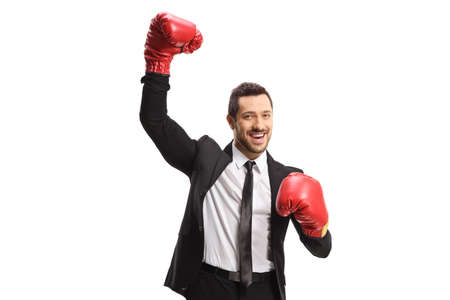 Businessman with boxing gloves raising one hand as a winner isolated on white backgroundの写真素材