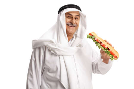 Happy arab man holding a tasty sandwich in a baguette isolated on white background