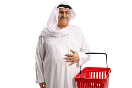 Smiling mature arab man with shopping basket isolated on white backgroundの写真素材