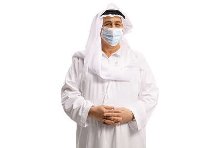 Arab man in a white robe and headscarf  wearing a protective face mask isolated on white backgroundの写真素材