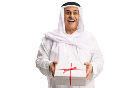 Cheerful mature arab man holding a gift box isolated on white background