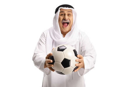Excited mature muslim man in white dishdasha holding soccer ball isolated on white backgroundの写真素材