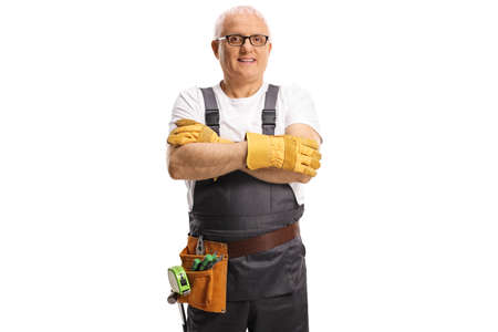 Repairman with a tool belt posing with crossed arms isolated on white backgroundの写真素材