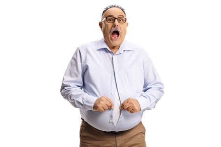 Shocked man with a big belly trying to button a shirt isolated on white backgroundの写真素材