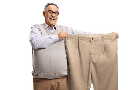 Smiling mature man showing a big size pants isolated on white backgroundの写真素材