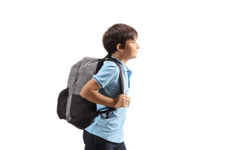 Profile shot of a schoolboy with a backpack isolated on white backgroundの写真素材