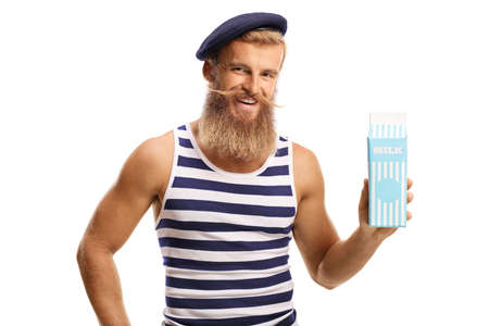 Bearded guy with a hat holding a pack of milk isolated on white backgroundの写真素材