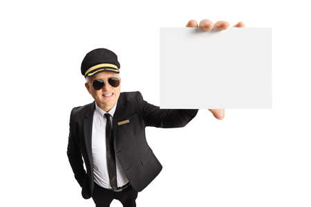 Chauffeur in a uniform and sunglasses showing a blank card in front of camera isolated on white...