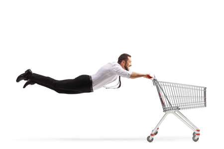 Man flying with an empty shopping cart isolated on white backgroundの写真素材