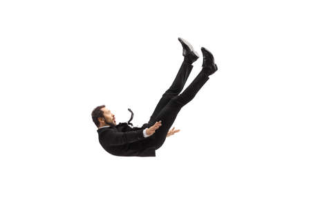 Man in suit and tie falling from above isolated on white background