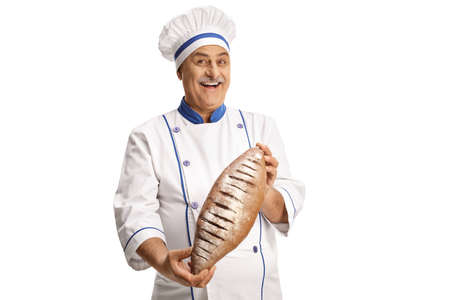 Cheerful mature male chef holding bread isolated on white background