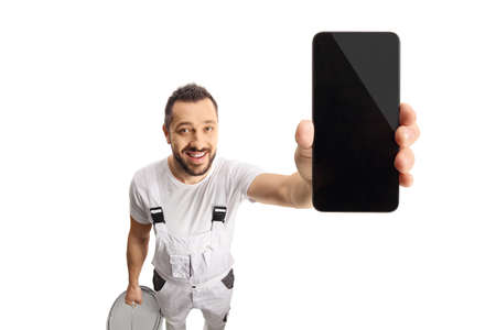 House painter holding a smartphone in front of camera isolated on white background