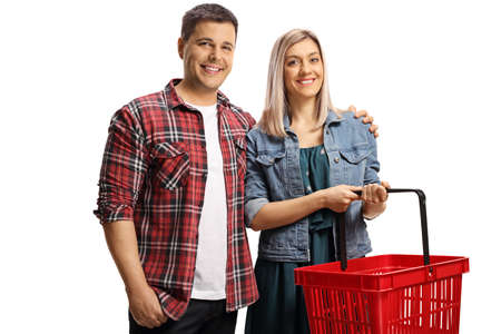 Young casual couple with a shopping basket smiling at camera isolated on white backgroundの写真素材