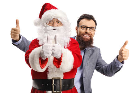Happy bearded man behind santa claus showing both thumbs up isolated on white backgroundの写真素材