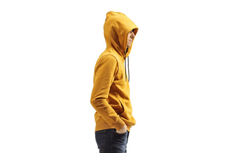 Profile shot of a guy wearing a yellow hood isolated on white backgroundの写真素材