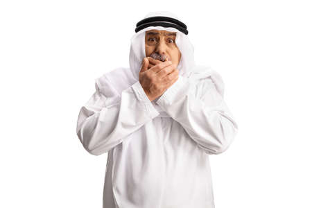 Scared mature arab man holding his mouth isolated on white background
