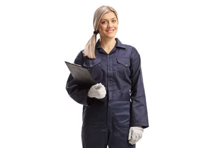 Young female worker in an overall uniform standing with a clipboard isolated on white background