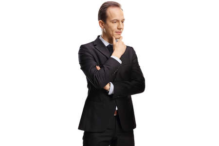 Pensive businessman holding his chin and looking to the side isolated on white backgroundの写真素材