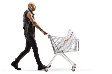 Full length profile shot of a punk man pushing a shopping cart with a bar chart diagram inside isolated on white backgroundの写真素材