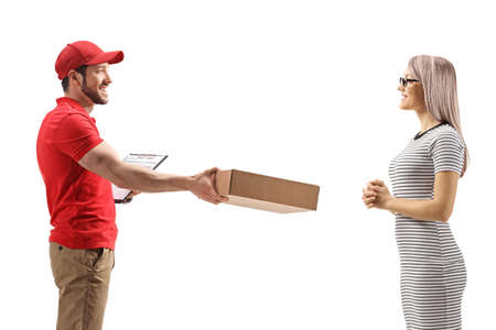 Delivery man handing a package to a young woman isolated on white backgroundの写真素材