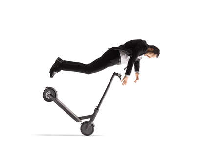 Businessman falling from an electric scooter isolated on white background