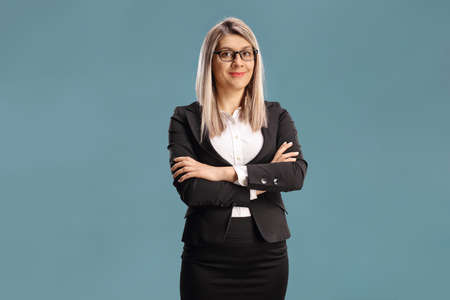 Businesswoman with glasses posing isolated on blue background
